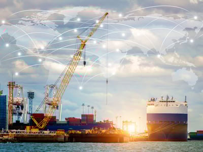 Shipping dock with a large yellow crane and a map of the supply chain imposed on it