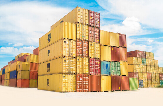 Stack of yellow red green and blue crates at a shipping yard